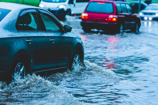 Car driving through puddle.